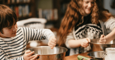 Family around a table making food